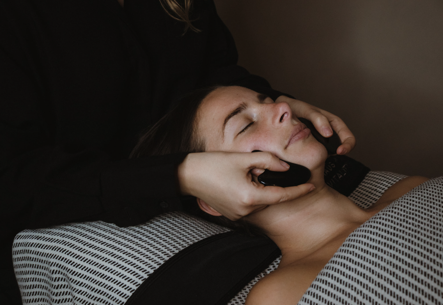 Woman relaxing during a facial at Haús of Vitality